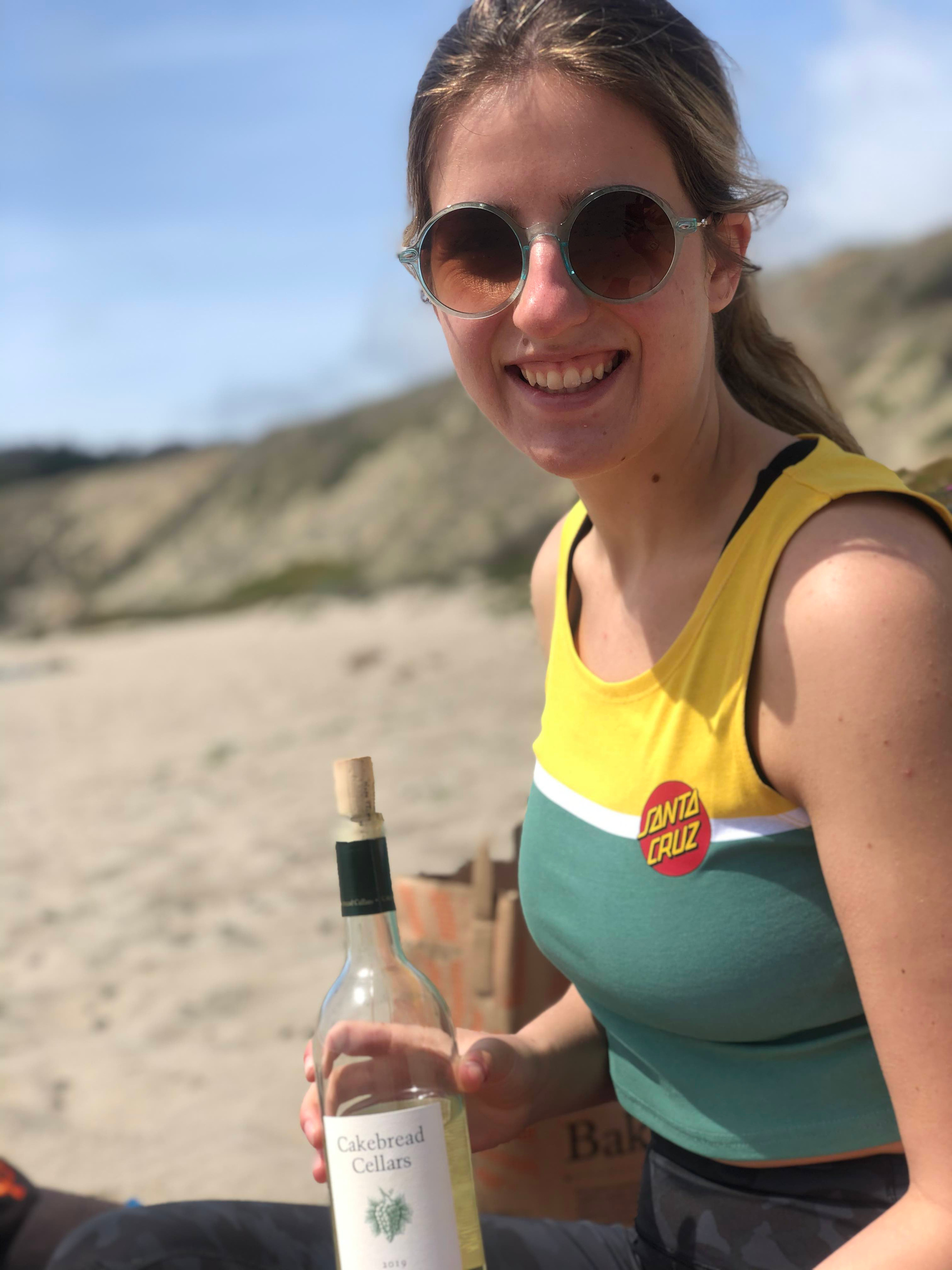 Abby deVarennes holding a bottle of Cakebread Cellars wine